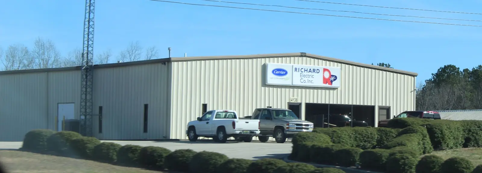 The Richard Electric shop on AL Hwy 157 in Cullman, with the Carrier and RICHARD Electric Co. Inc. sign and two company pickups out front