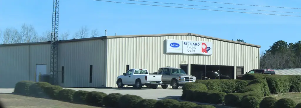 The Richard Electric shop on AL Hwy 157 with the Carrier and RICHARD Electric Co. Inc. sign and two company pickups out front
