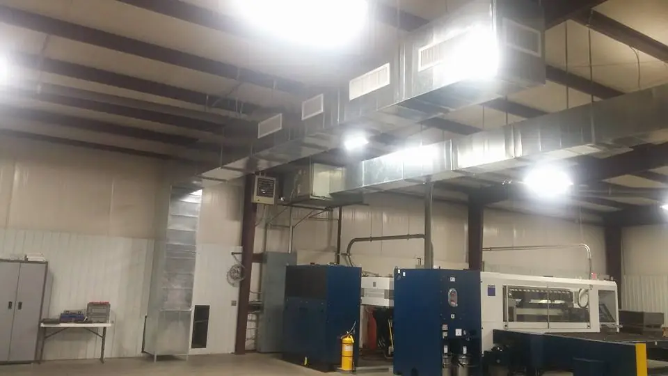 The industrial shop interior with ductwork and metal-working machinery