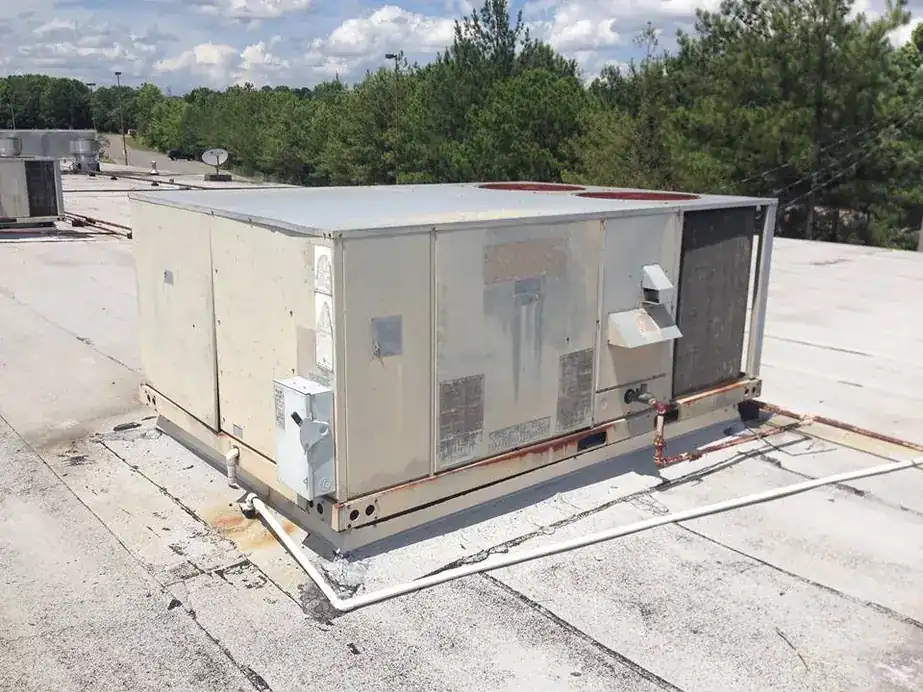 Rooftop unit with a line of trees behind it