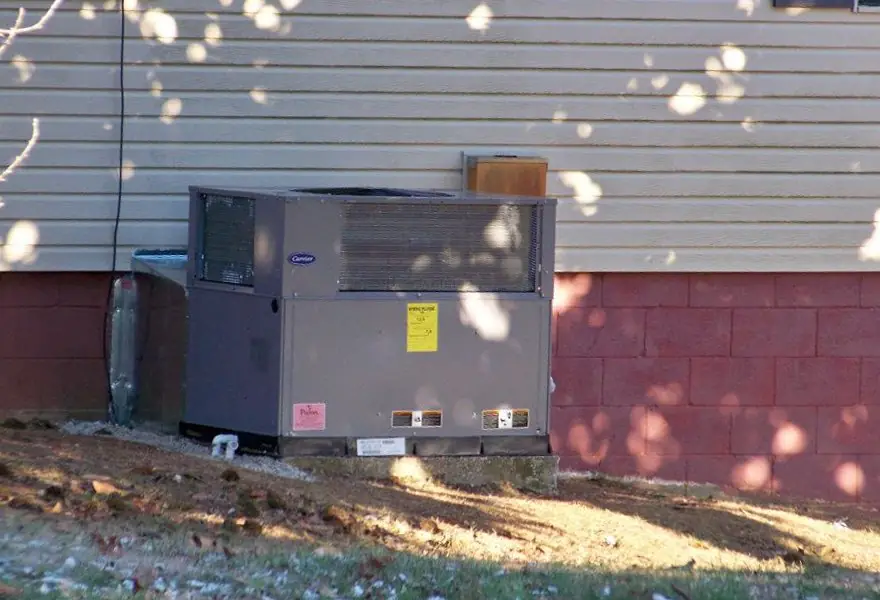 Carrier package unit set on a red brick base